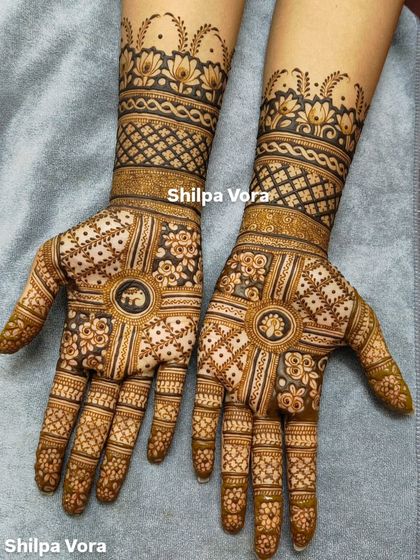 A full-hand design with a central elephant motif, surrounded by floral and geometric patterns.