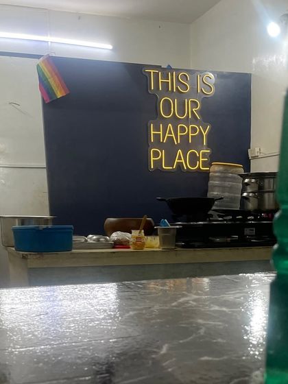 Our kitchen space at night, with the "This Is Our Happy Place" sign glowing. It's a reminder of the safe and joyful environment we strive to create.