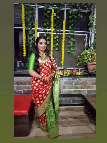 This beautiful red and green Banarasi saree is a classic combination. The drape is kept simple to let the rich colors and fabric be the focus.