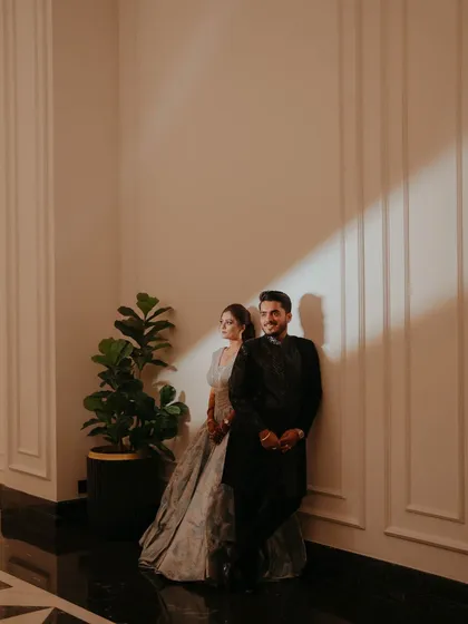 A stylish, editorial-style portrait of the couple, using dramatic lighting to create a moody and romantic feel.