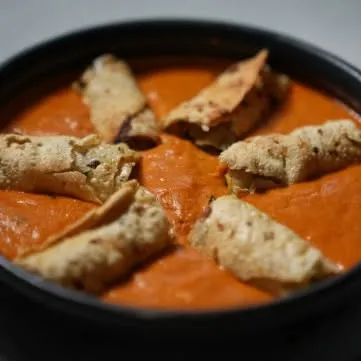A creative twist on a classic, this dish features our Gajar Cheese Rolls served in a creamy, tomato-based gravy, turning a starter into a unique main course.