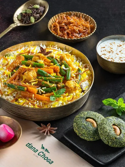 A festive plate of vegetable biryani served with hara bhara kebabs for Dana Choga.