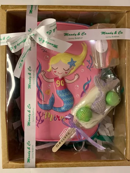 The ultimate mermaid-themed hamper, beautifully packaged with a mermaid pouch, popsicle soap, and other themed goodies.