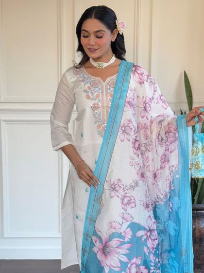 This off-white viscose chanderi kurta is a classic. The delicate embroidery and printed floral dupatta in shades of blue add a touch of color and grace.