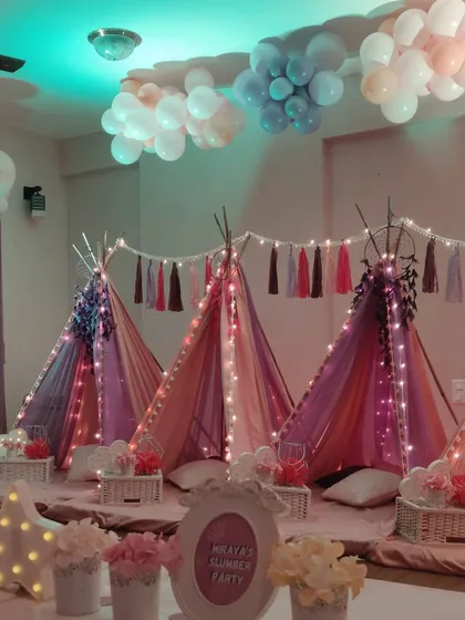 I create the coziest, most magical sleepovers. This slumber party setup features individual teepees adorned with fairy lights and plush cushions, with dreamy balloon clouds on the ceiling to make for an unforgettable night with friends.