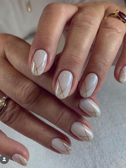 A sophisticated and elegant design for a wedding or special event. A milky white base is adorned with delicate, intersecting lines of gold and silver glitter.