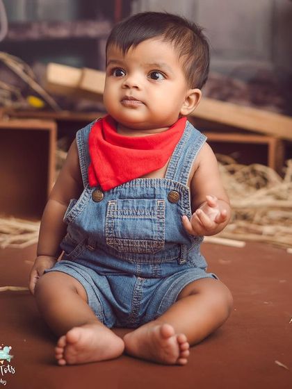 A rustic farm or ranch theme is perfect for a little cowboy. We use hay, wooden crates, and a cute bandana to complete the look.