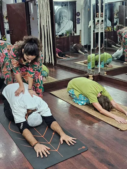 Here in my Delhi studio, I'm providing a hands-on adjustment during a Teacher Training class. I believe in giving personalized attention to help each student safely deepen their posture and understand the alignment of each asana.
