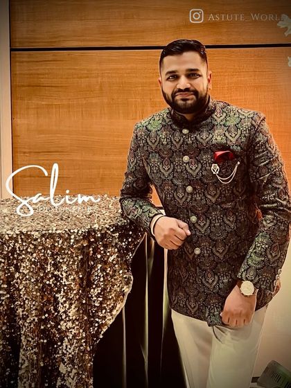 A client looking distinguished in a pashmina wool Jodhpuri suit with a classic pattern. The addition of a brooch and pocket square elevates this traditional outfit.