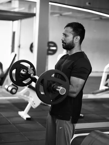 The bicep curl with a barbell, a classic movement for building arm size and strength. We focus on controlled movements for maximum muscle engagement.