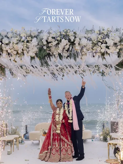 As sparklers lit up the twilight sky over the ocean, they threw their hands up in pure joy. This is the moment forever begins, a perfect, explosive celebration of two people, two families, and one incredible future.