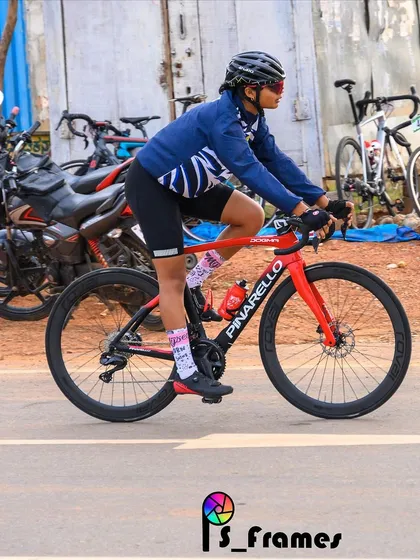 A female rider on her Pinarello race bike, captured during a race. We celebrate our women racers who are breaking barriers and setting new benchmarks.