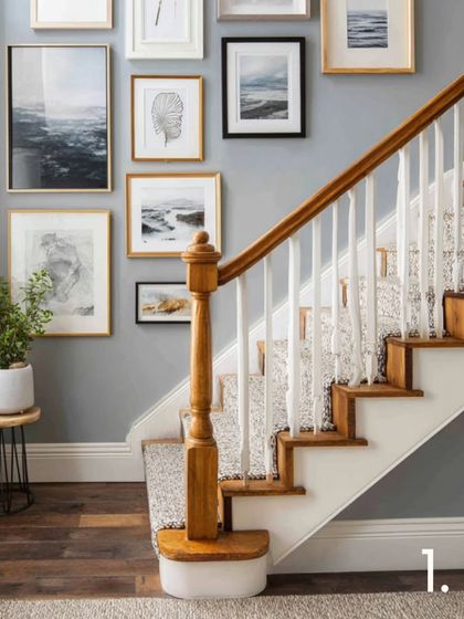 A soft and serene staircase gallery wall can create a refreshing, airy feel. This layout combines light wood and black frames with nature-inspired prints, giving the space a sense of modern calm.