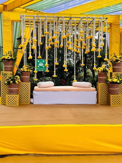 The complete Haldi stage, a perfect blend of modern structure and traditional floral decoration.