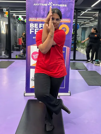 A smiling participant enjoying the yoga challenge. Our classes are designed to be both challenging and enjoyable, fostering a positive relationship with exercise.