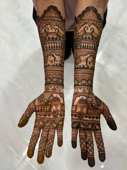 An elegant engagement design featuring traditional Indian architecture (jharokhas), lotus flowers, and elephants, covering the hands and forearms.