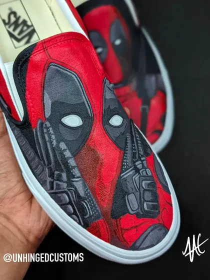 Chimichanga time! A close-up of these custom Deadpool Vans Slip-Ons. The cross-hatching style gives it a gritty, comic book feel.