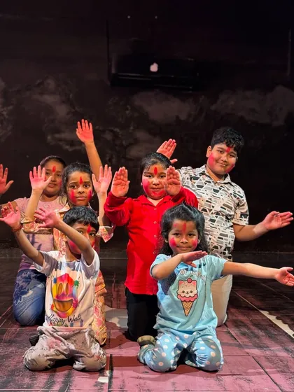 Our youngest dancers posing with colorful hands during our vibrant Holi celebration.