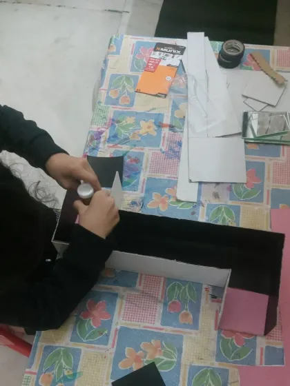 Here you can see the careful work of gluing and assembling the periscope. I guide them on the technique, but they do the hands-on work to truly learn the process.