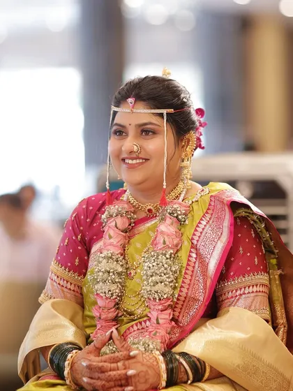 The complete look, with the bride seated at the mandap. Her makeup is flawless, her hair is perfectly styled, and she radiates confidence.