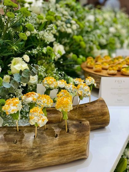 Our Broccoli Lollipops, creatively displayed on wooden logs. This is an example of how we design unique and thematic presentations for brand events.