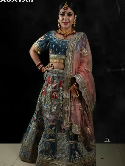 A professional studio shot of the Doli Barat lehenga. The dark background makes the colors and detailed artwork on the skirt pop.