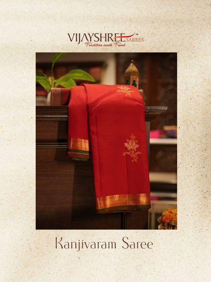 Elegance redefined in this red Kanjivaram saree, adorned with intricate gold and silver floral motifs and a subtle green border.