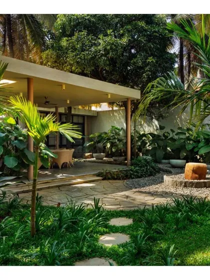 A view of the landscaped garden, featuring stone pathways and a mix of native grasses and plants. The design creates a private, peaceful environment for the residents.