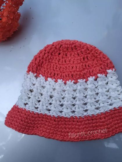 The Bonnie Bell Sunhat laid flat. The pattern combines solid and mesh-like stitches, which makes it both protective and breathable.