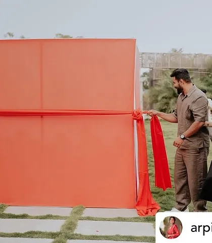 The anticipation builds. The setup for our car unboxing reveal features a large fabric wall that can be pulled away in a single, dramatic motion.
