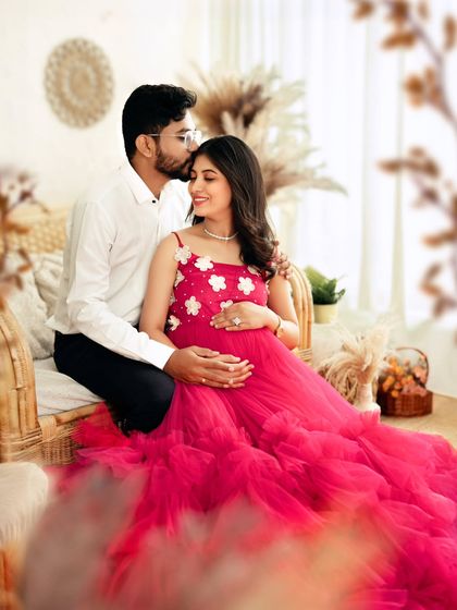 A tender moment as the dad-to-be kisses his partner's forehead, a perfect expression of love and support.