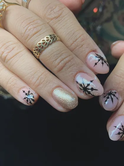A chic winter or Christmas design with black snowflakes over a nude and gold glitter base.