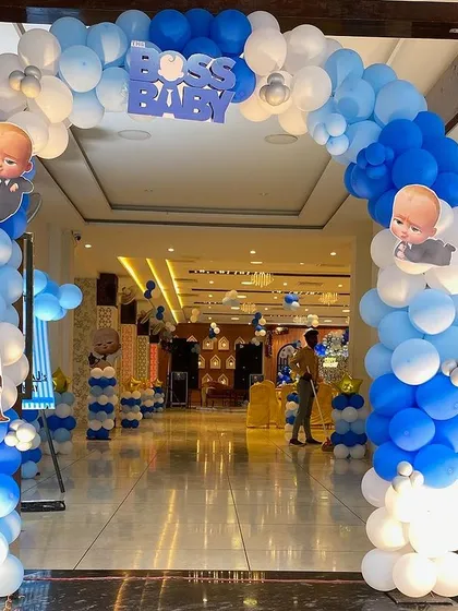 A grand entrance arch for a Boss Baby themed party. This blue and white balloon arch with character cutouts creates an impressive welcome for guests.