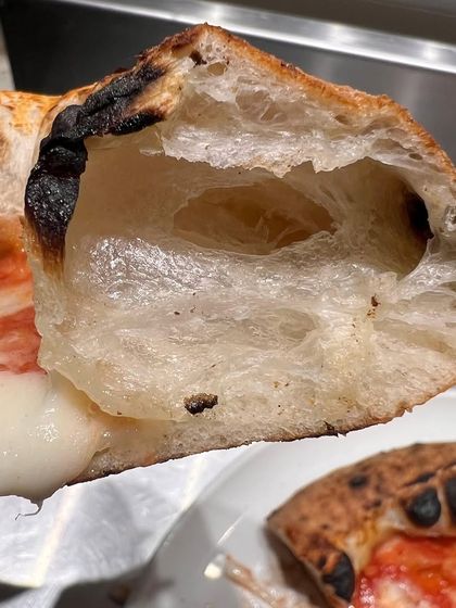 Another look at our crust experiments. The goal is always that perfect "cornicione," the puffy, leopard-spotted edge that's a hallmark of true Neapolitan pizza.