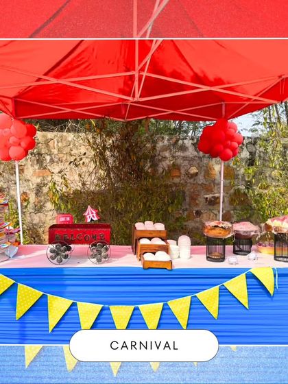 The food station at a carnival party, set up under a red canopy with colorful bunting. This image shows the vibrant and festive environment I create for your celebration.