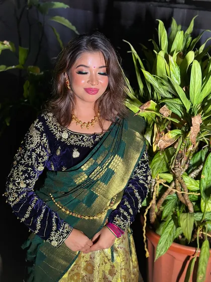 The bride-to-be in her elegant half-saree, showcasing the beautiful velvet blouse and the soft, romantic makeup.