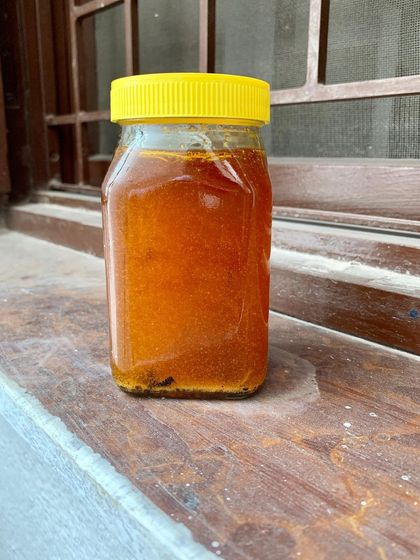 A jar of our golden, rendered pork lard. We infuse it with rosemary and garlic, creating a flavorful fat that is perfect for frying eggs, sautéing vegetables, or adding a rich base to your sauces.