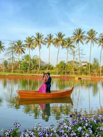 Another beautiful wide shot of the couple on the lake, showcasing the stunning reflections and vibrant colors of their pre-wedding location.
