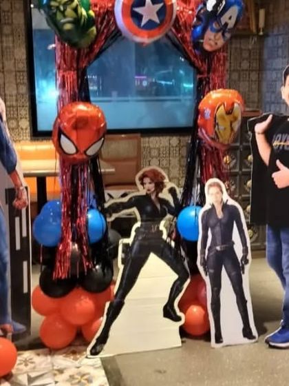 The birthday boy posing with a Spiderman cutout at his Avengers-themed party. We can provide various photo opportunities and props for guests.