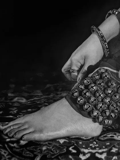 This composition focuses on the foot and the ghungroo, set against the intricate pattern of the carpet. The interplay of textures is what brings this monochrome scene to life.