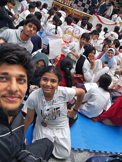A selfie with my students during a tournament, capturing the excitement and supportive atmosphere of competition day.
