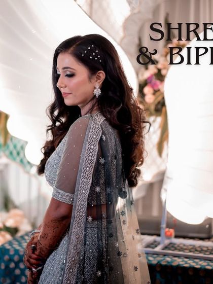 An angelic portrait of the bride, with white wings in the background adding a whimsical, fairytale touch to her reception look.