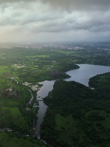 आपले कोंडेश्वर, बदलापूर. Our Kondeshwar. A wide aerial panorama showing the lake and the surrounding greenery, a popular spot for locals to escape the city.