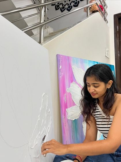 I find so much joy in the process. Here I am applying texture paste to the second canvas of my floral series, with the first completed piece in the background inspiring the next step of the journey.