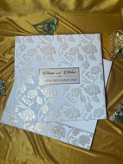 The full embossed invitation set. The simplicity of the white and gold color palette allows the beautiful texture to be the star of the show.