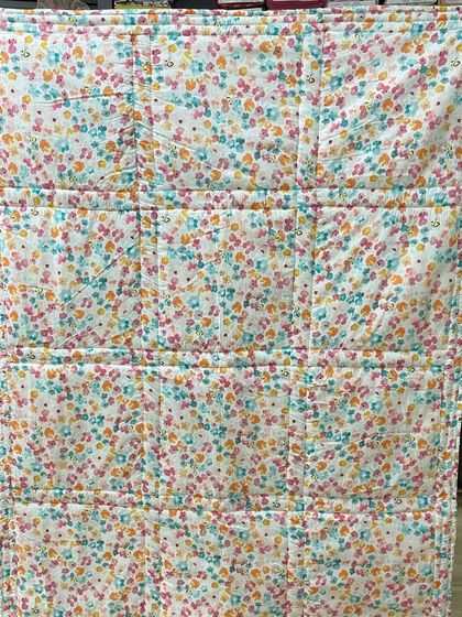 The back of the colorful baby quilt.