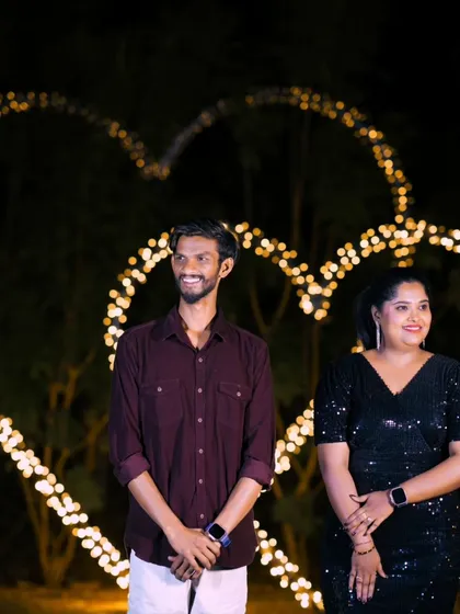 A candid moment of joy in front of a heart-shaped light installation. We capture the real emotions and happiness of our couples.