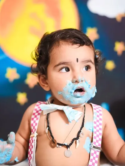 Covered in blue frosting and happiness. This superhero-themed cake smash was all about celebrating this little guy turning one with a fun and playful setup.