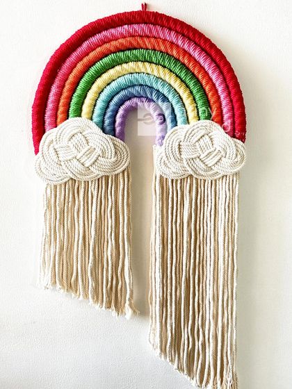 A close-up of the classic rainbow. The bright, happy colors and the intricately knotted clouds make this a timeless piece that brings joy wherever it hangs.