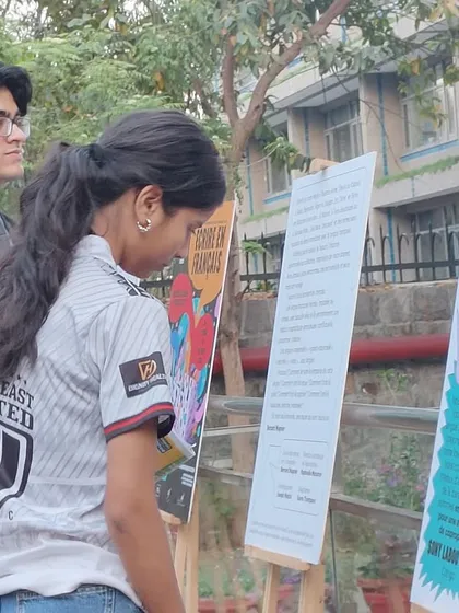 Students engage with the 'Écrire en français' exhibition panels displayed on our campus grounds. Learning here happens both inside and outside the classroom.